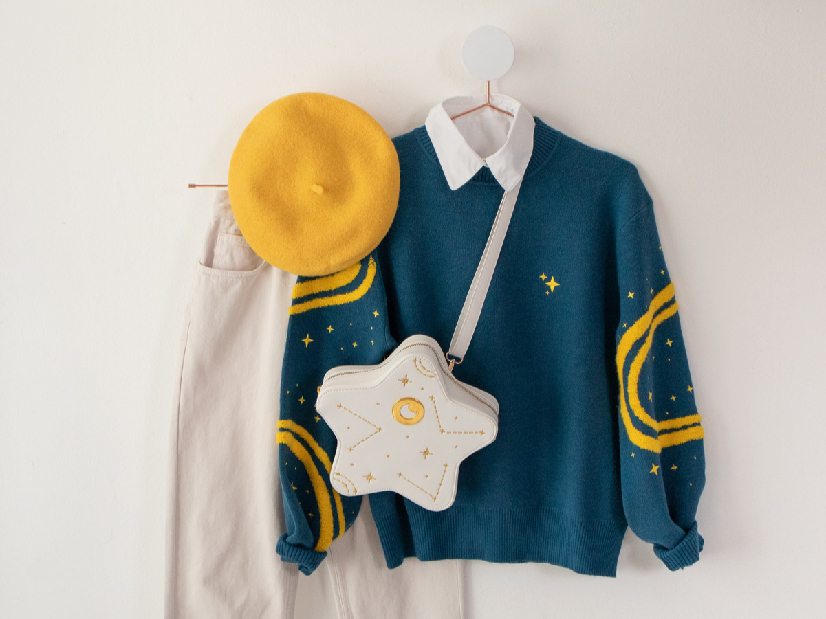 Blue Stargazer Sweater outfit with Star Bag, yellow beret, and off-white pants.