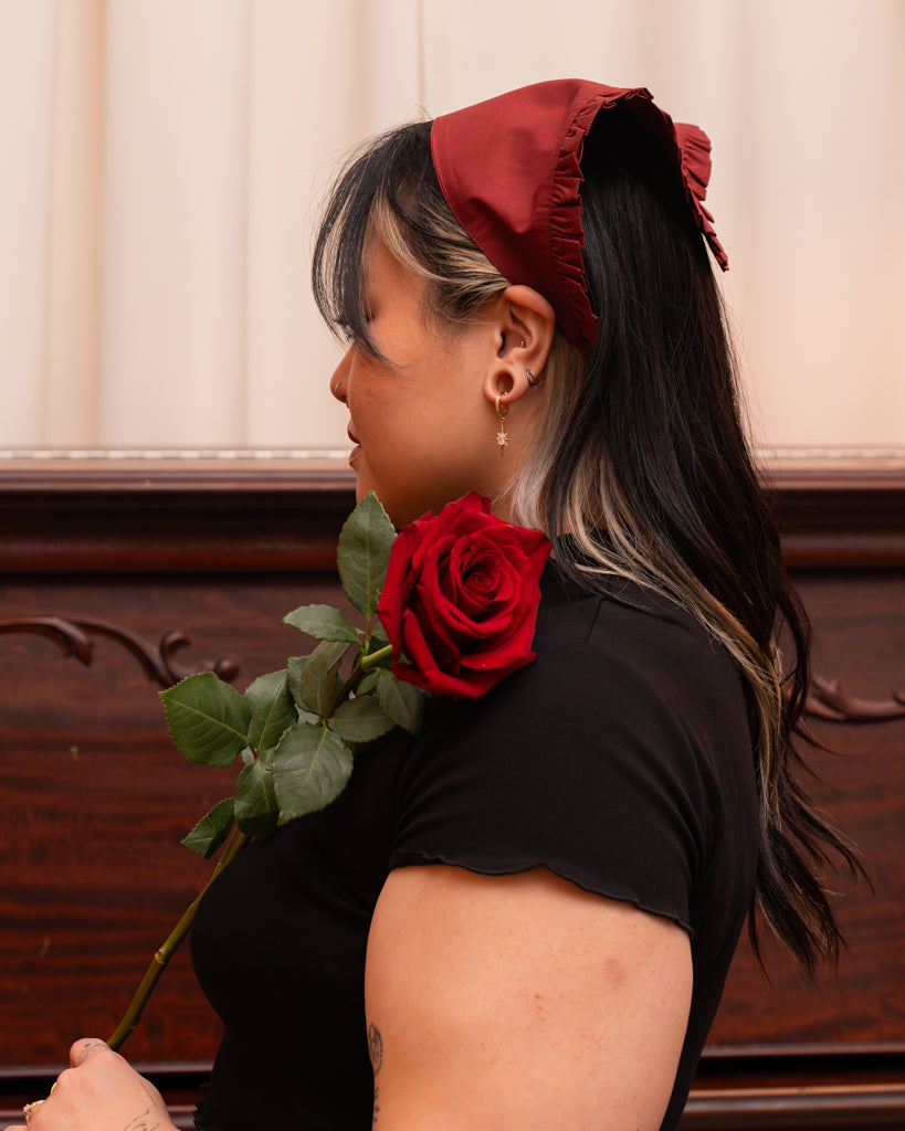 Side view of model wearing red belle bandanna.