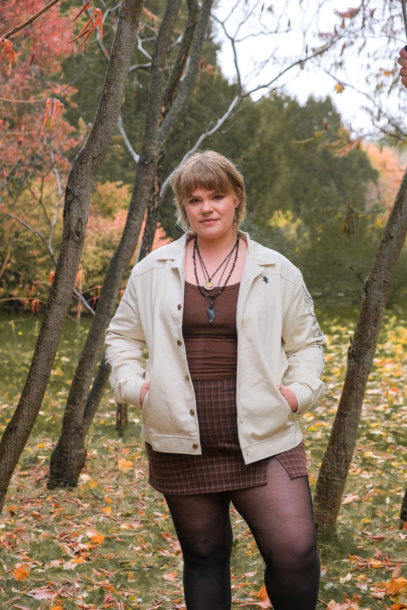 Woman wearing white better luck next time jacket in size extra large in forest.