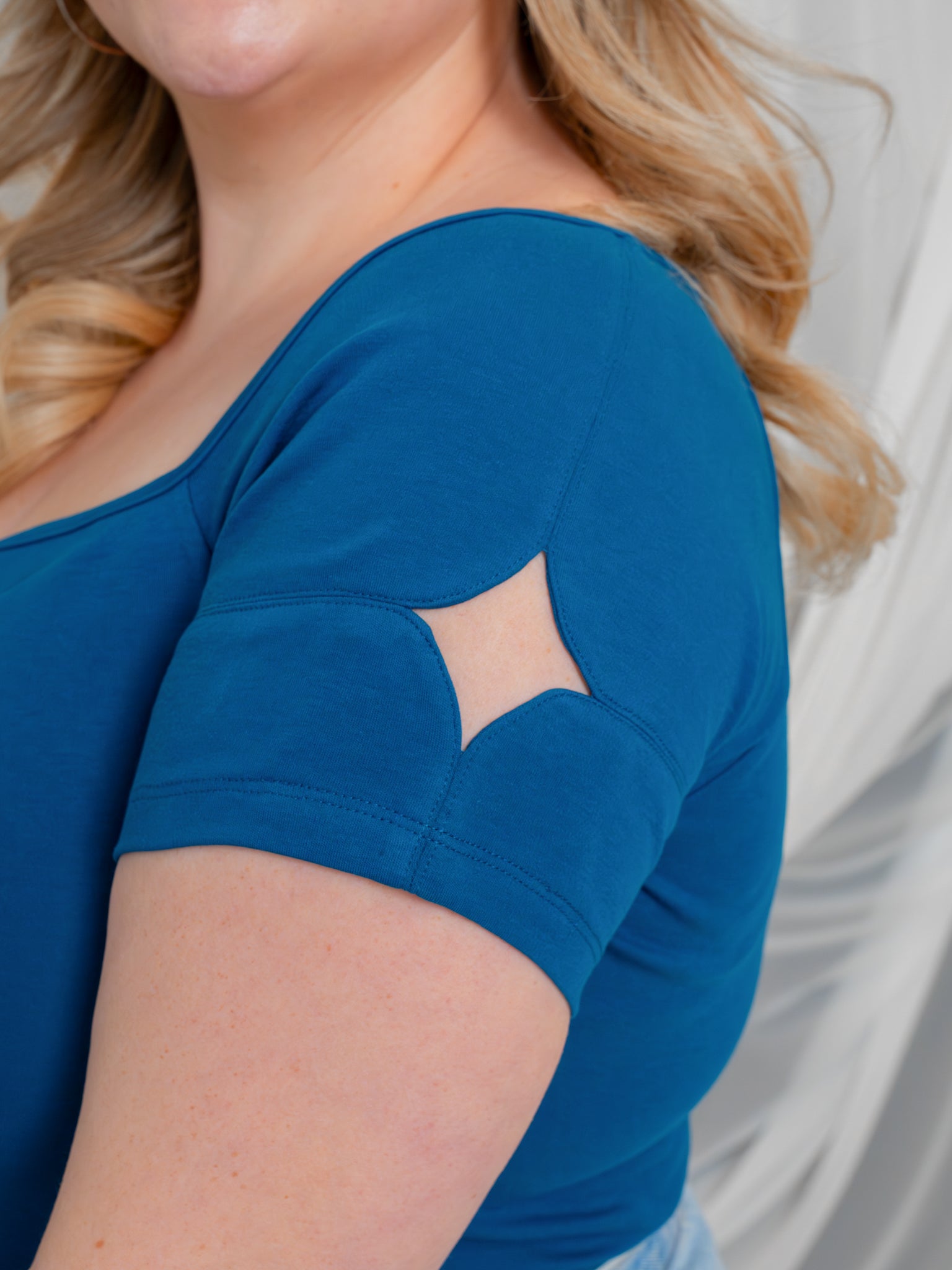Close up of blue moon (blue) cap sleeve sparkle cut out.
