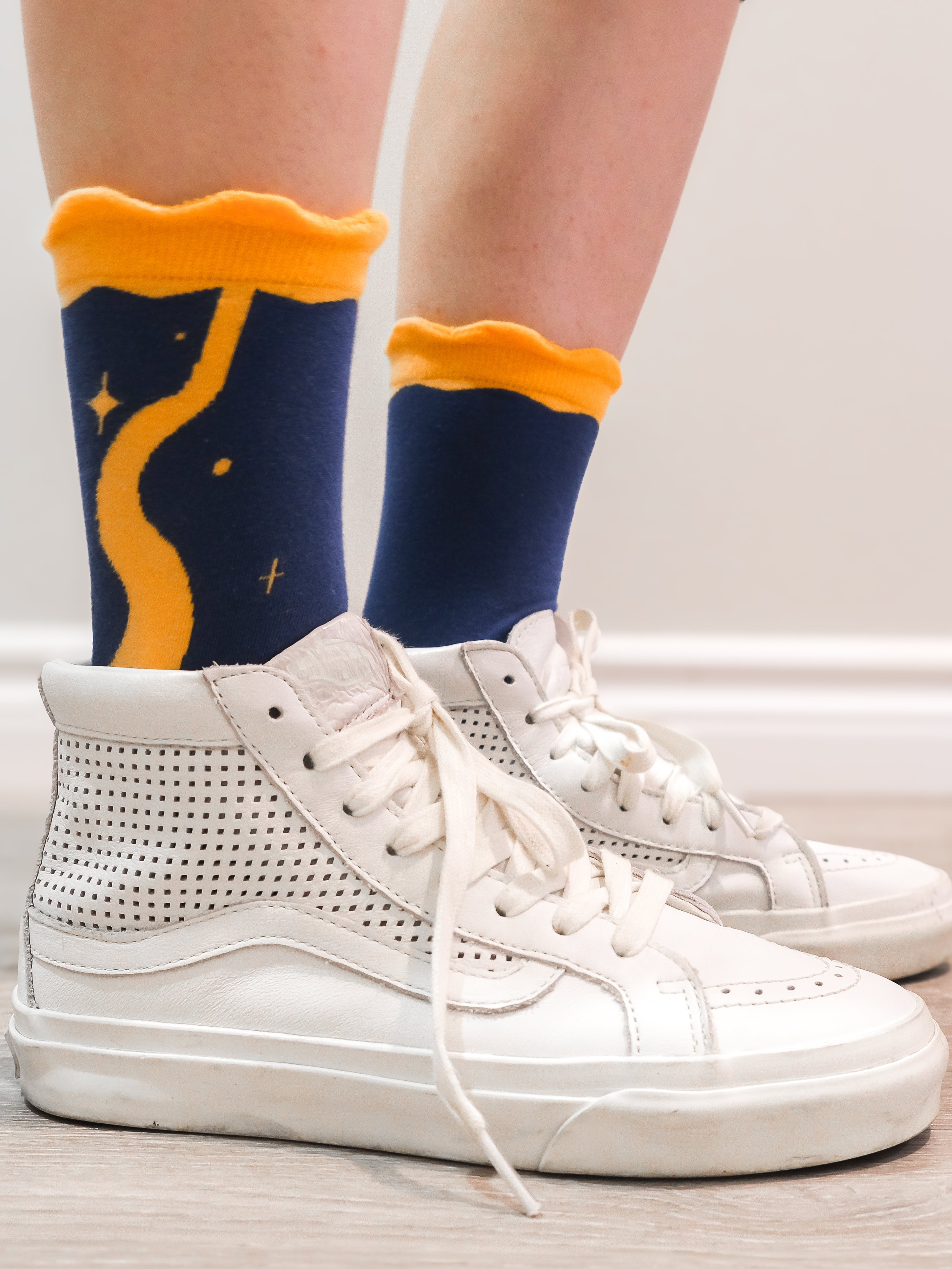 Blue moon socks worn with white sneakers.