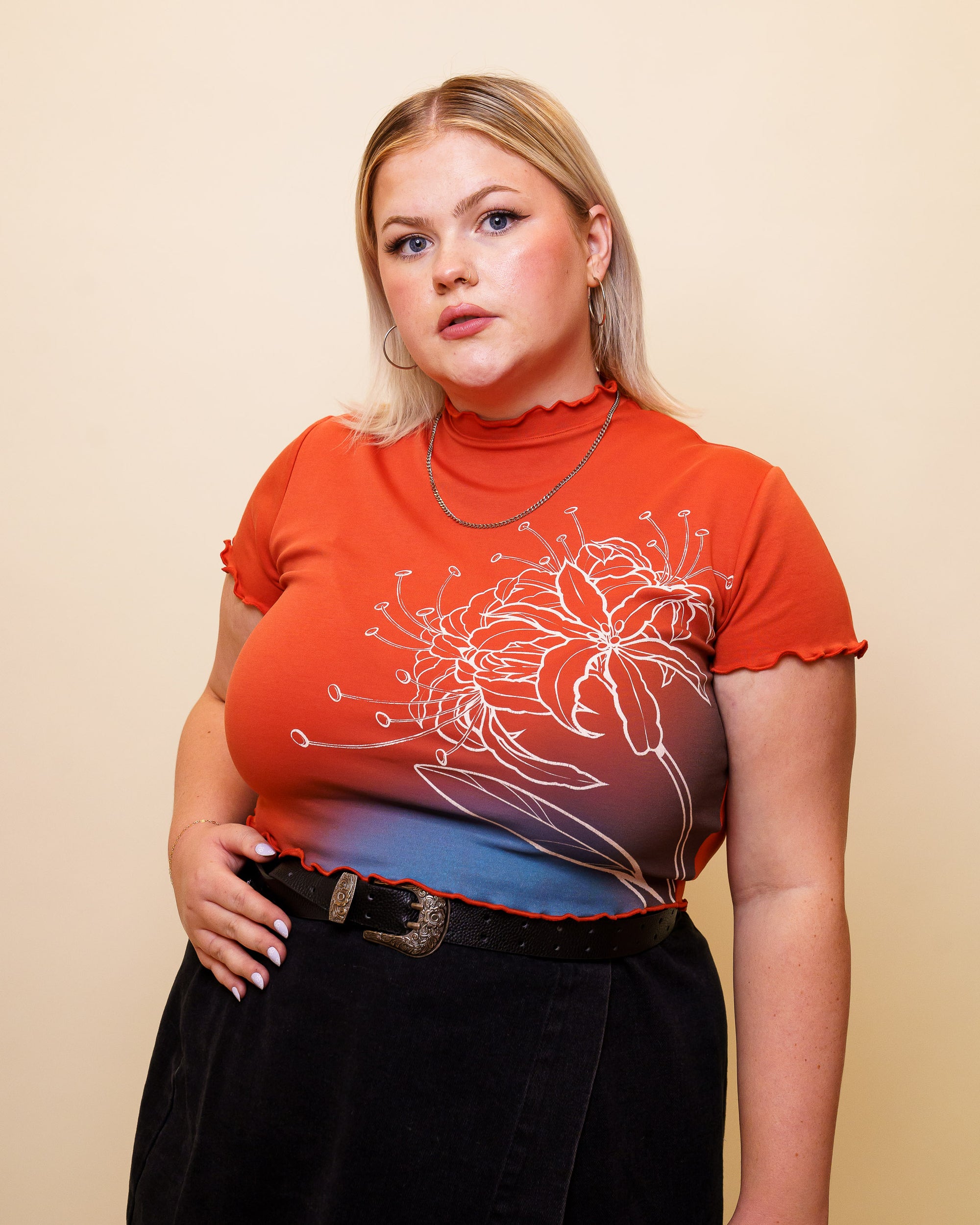 Woman wearing red calling card mini tee in size large.