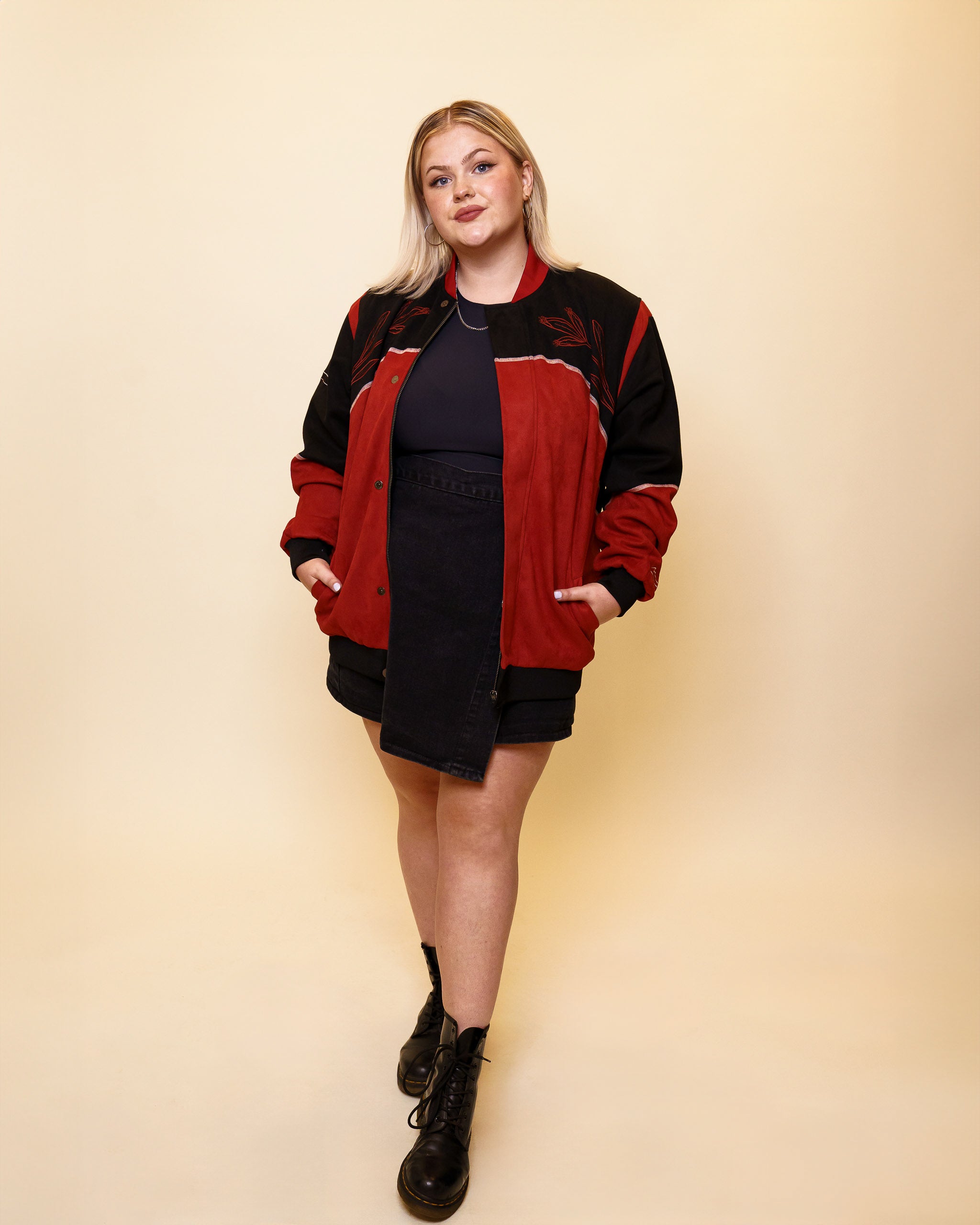 Woman wearing calling card faux-suede jacket in size large with black skirt.