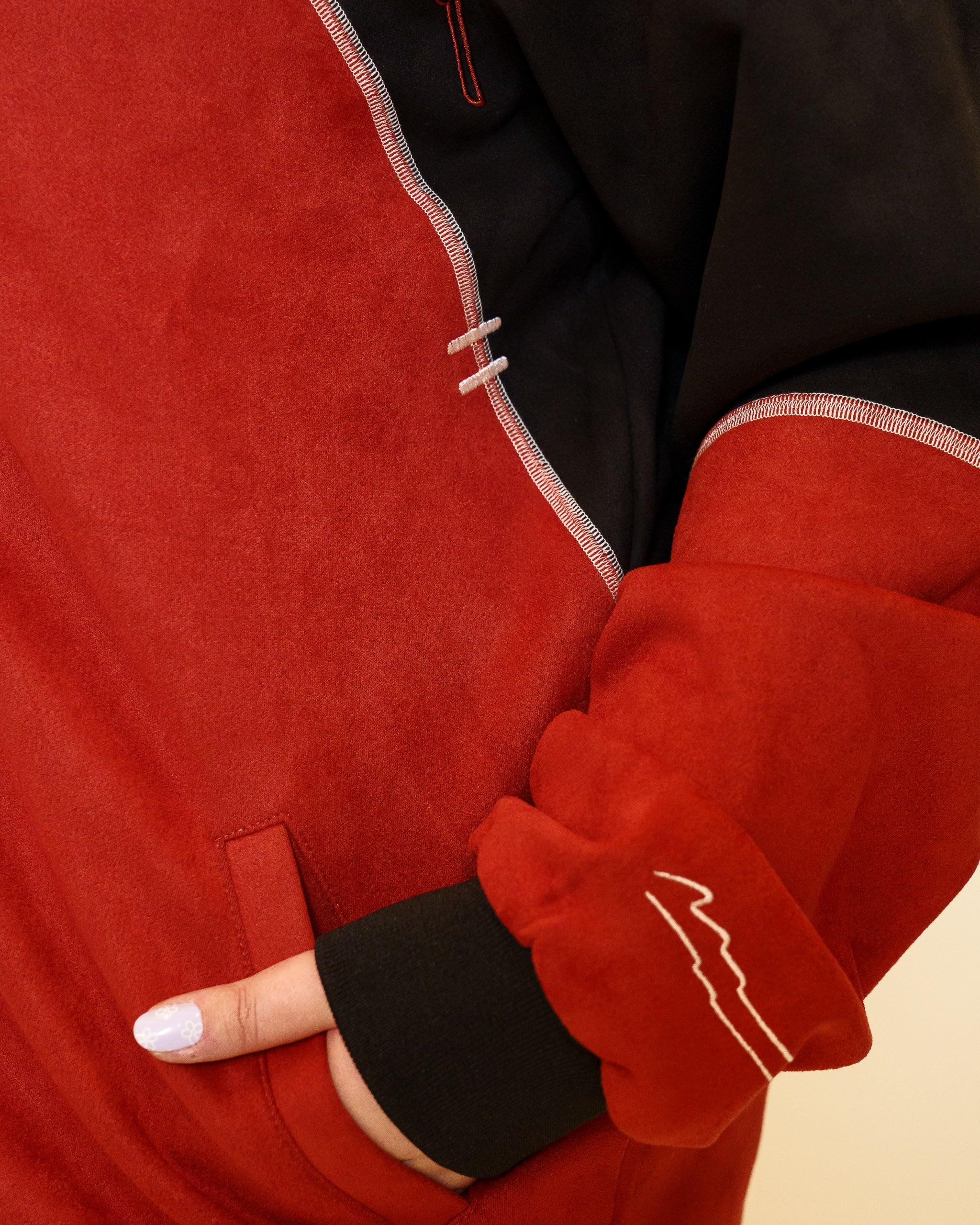 Close up of calling card faux-suede jacket pocket.