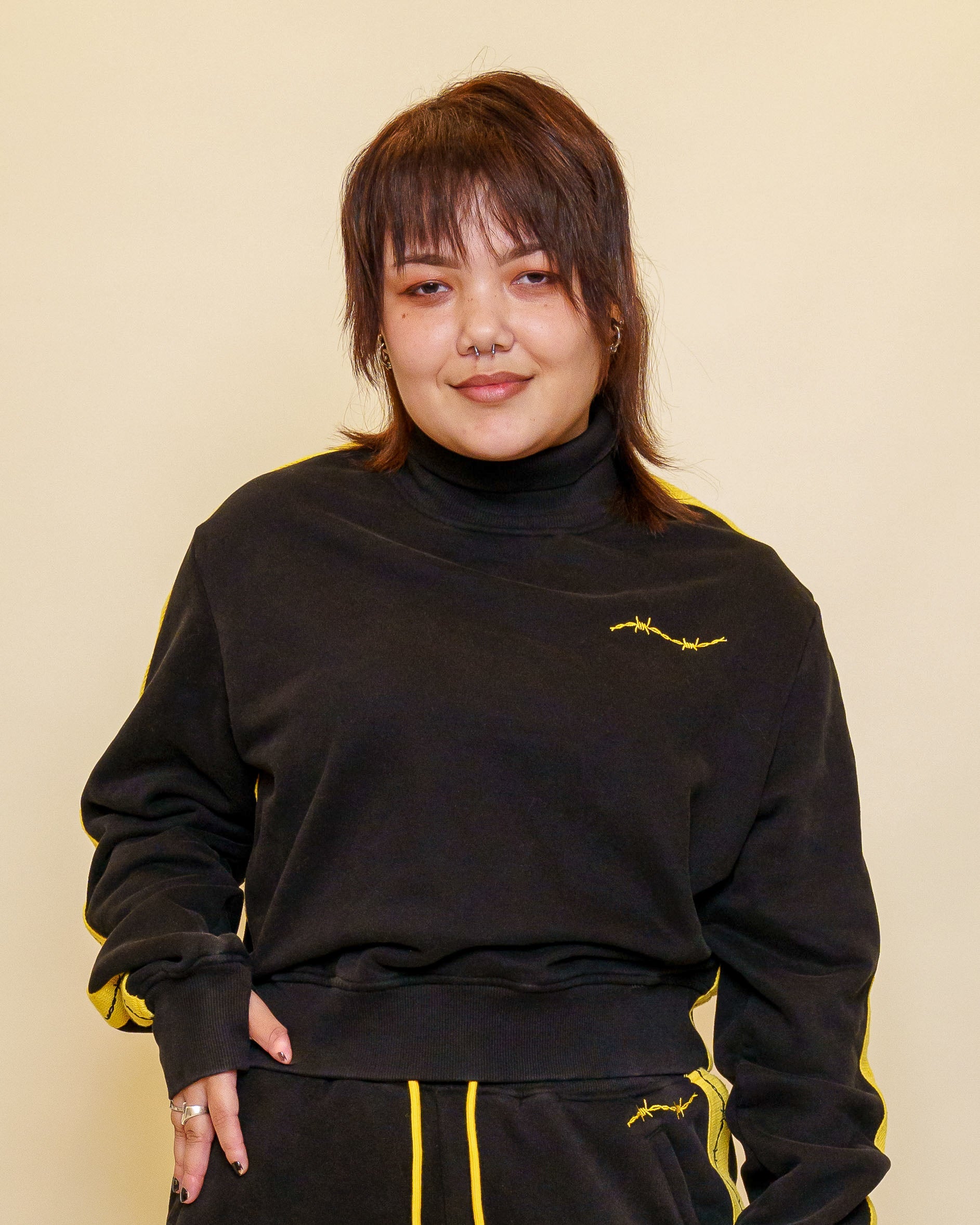 Woman wearing caution cropped mock neck sweater in size medium.