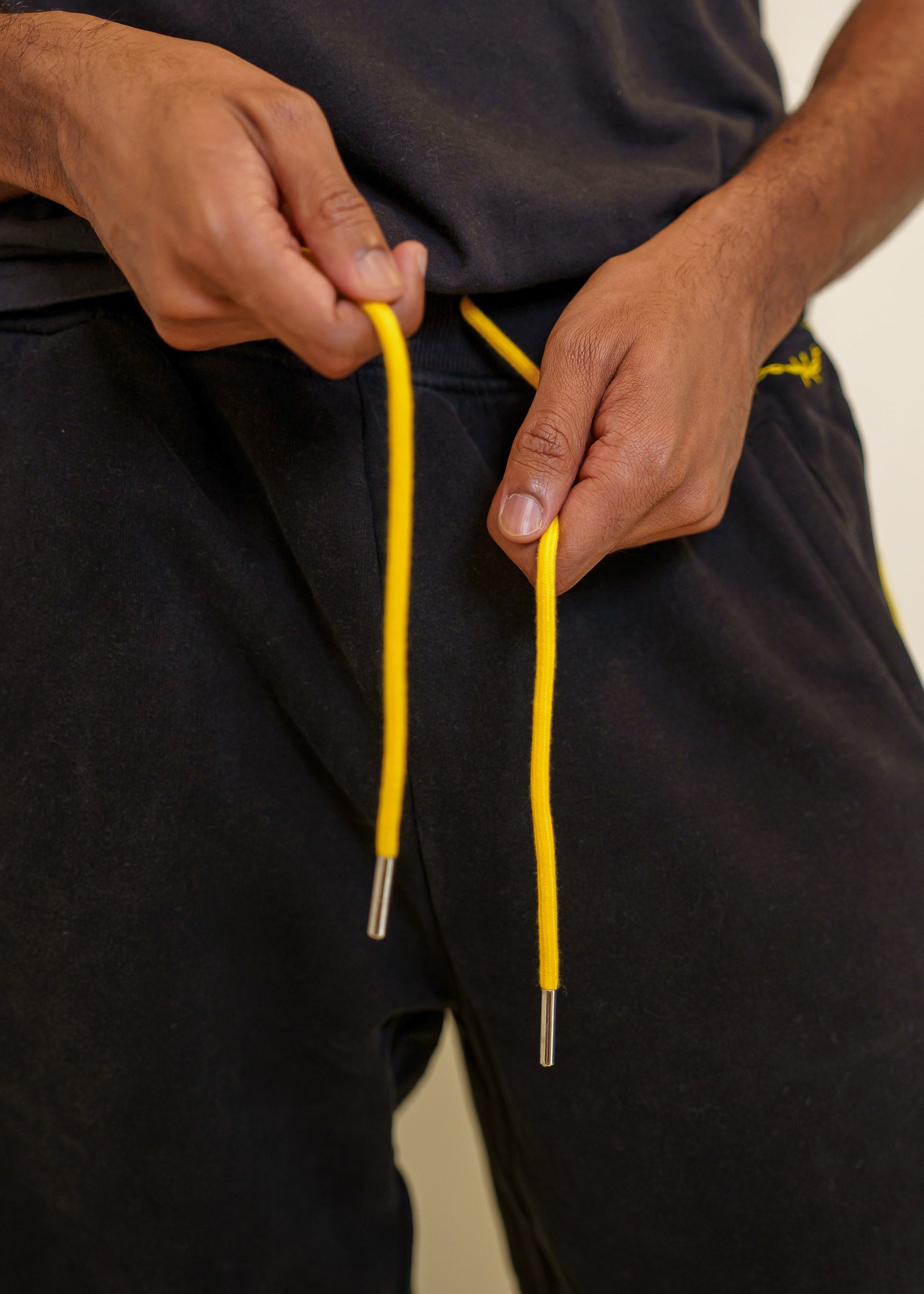 Close up of caution joggers yellow waistband ties.