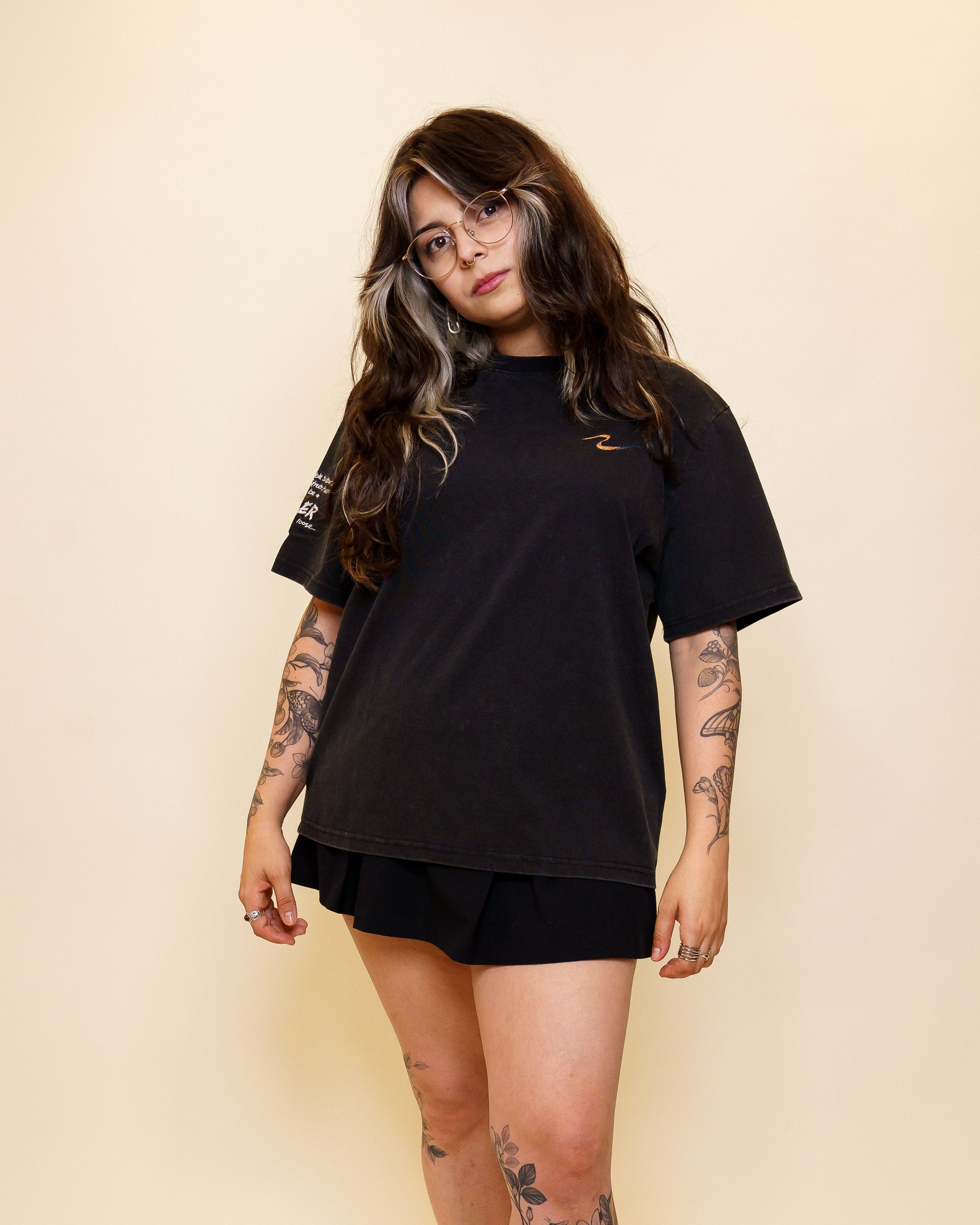 Woman wearing cold case tee facing forwards in size 40 with a black skirt.