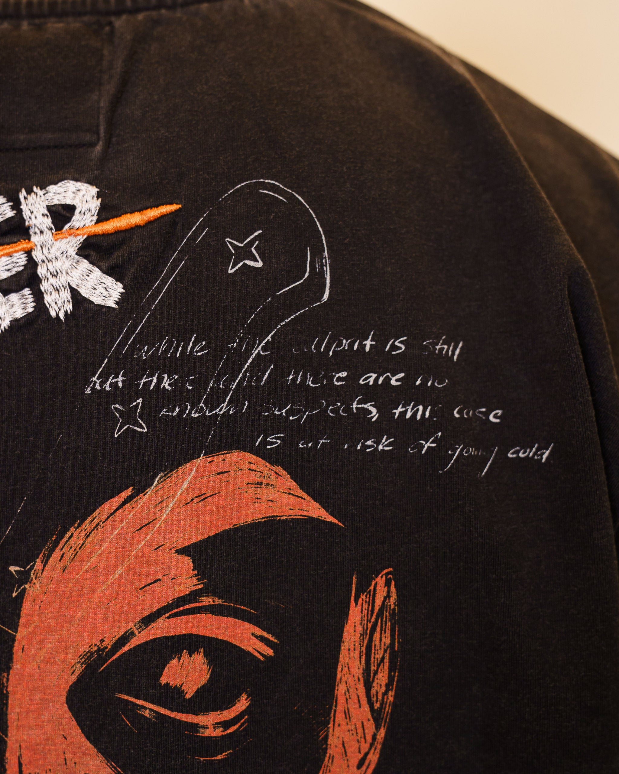 Close up of cold case tee text detail on back.