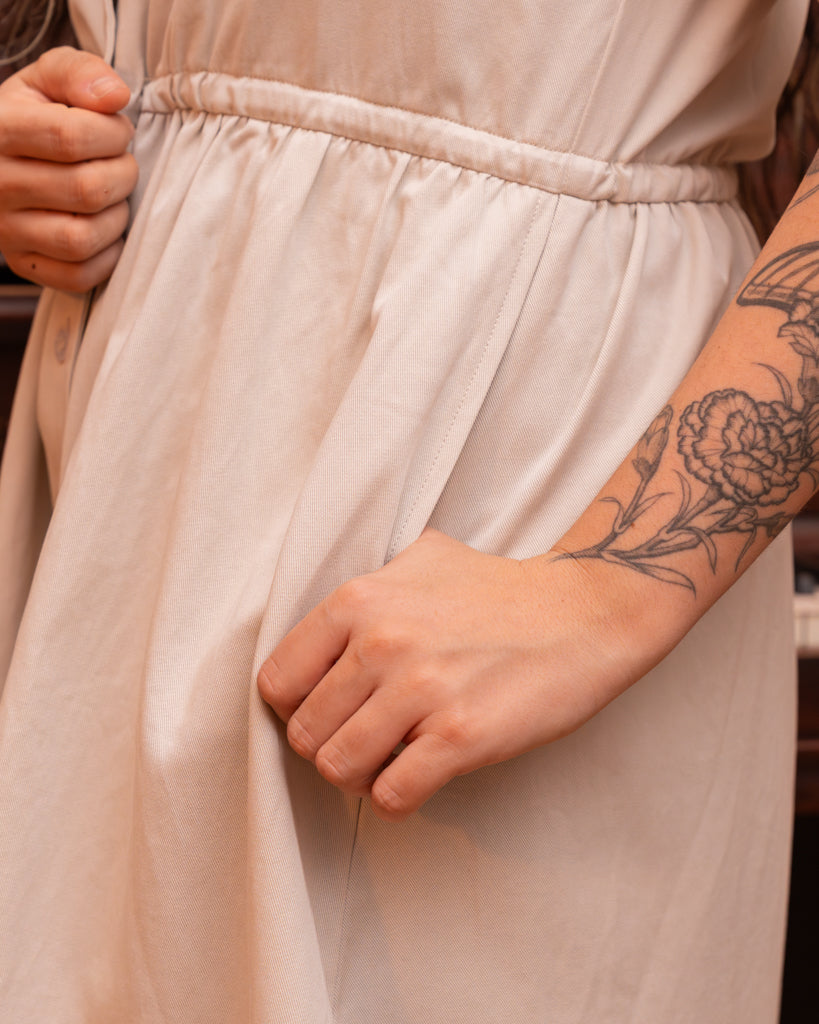 Close up of curtsy white smock dress pocket.