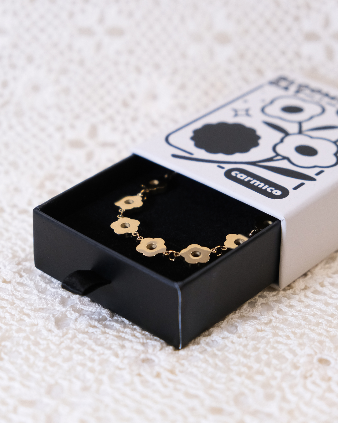 Golden daisy chain in packaging.