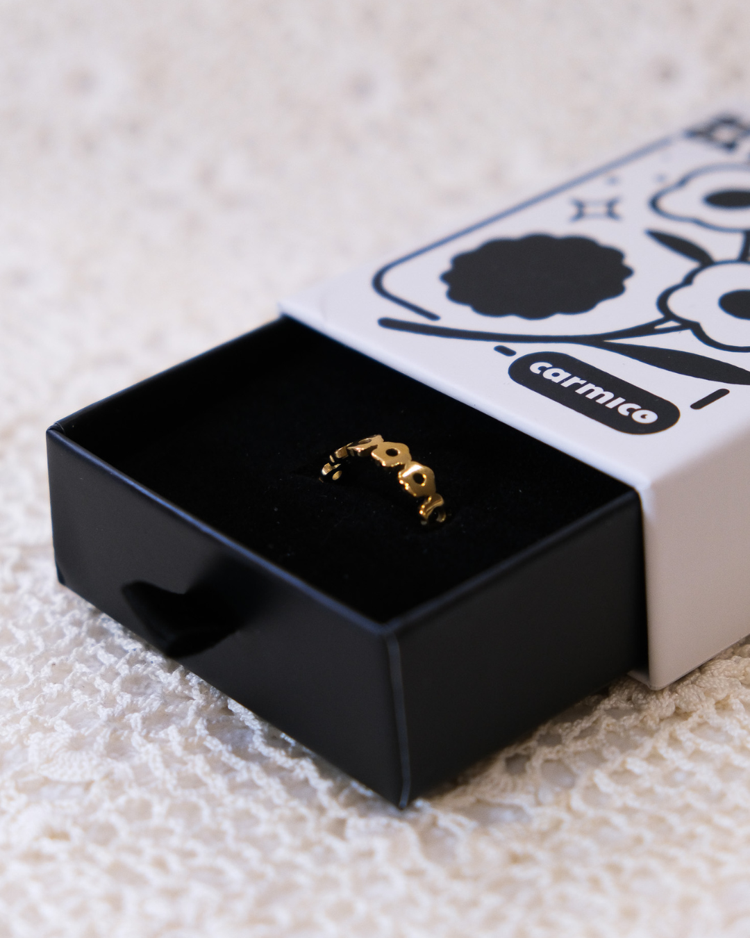 Golden daisy ring in packaging