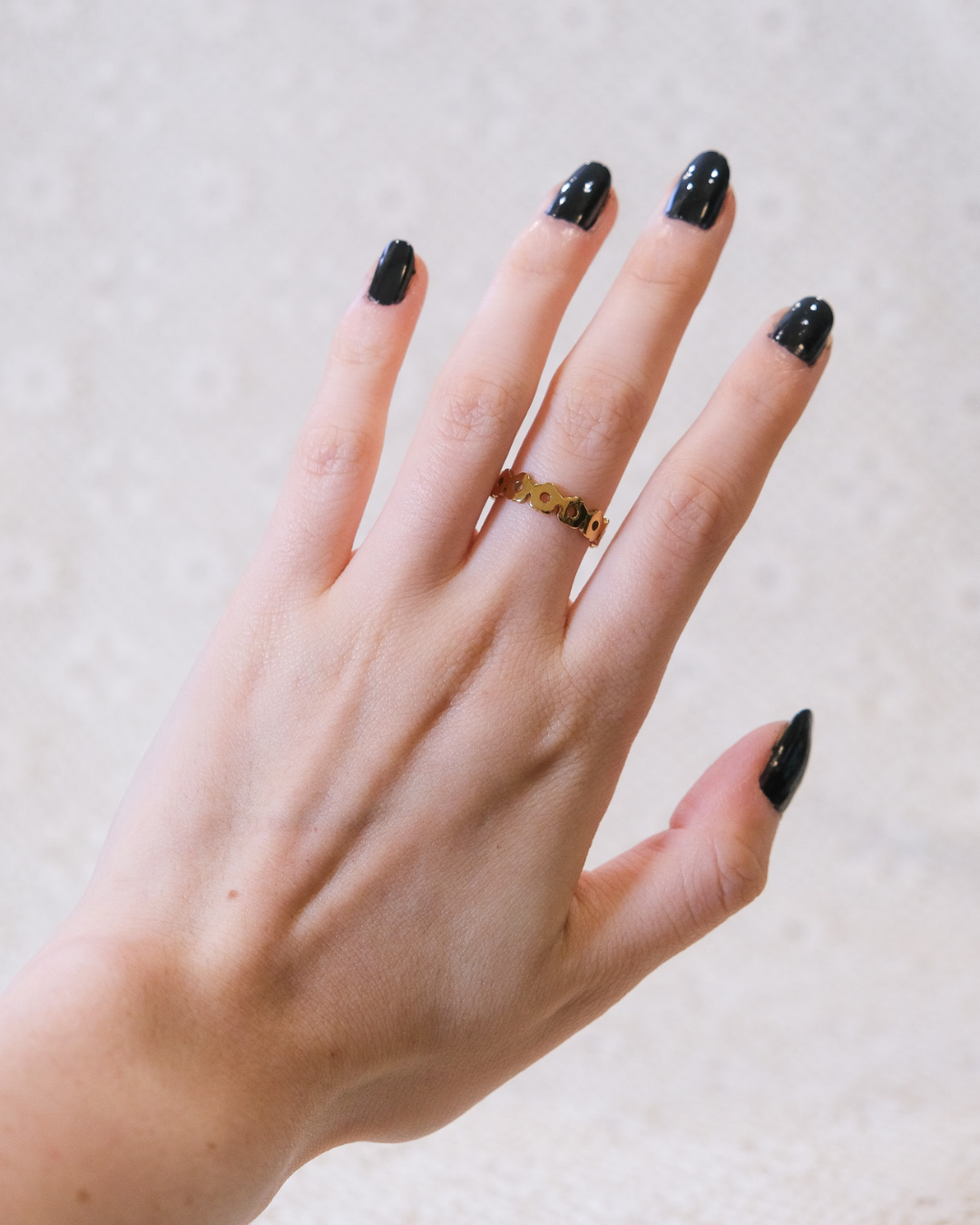 Golden daisy ring being worn.