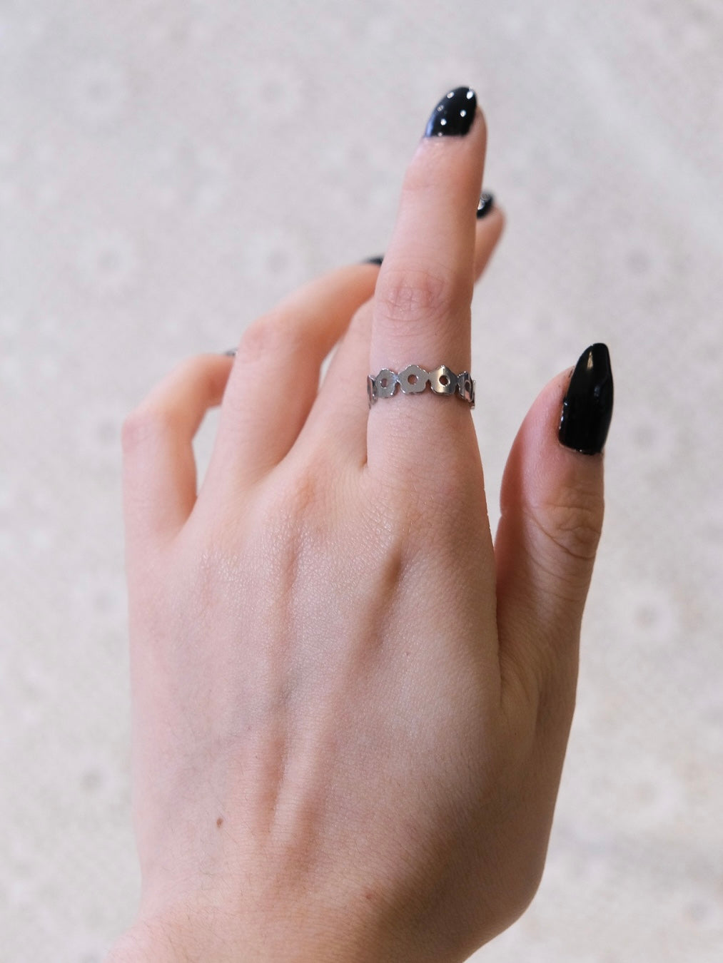 Silver daisy ring being worn.