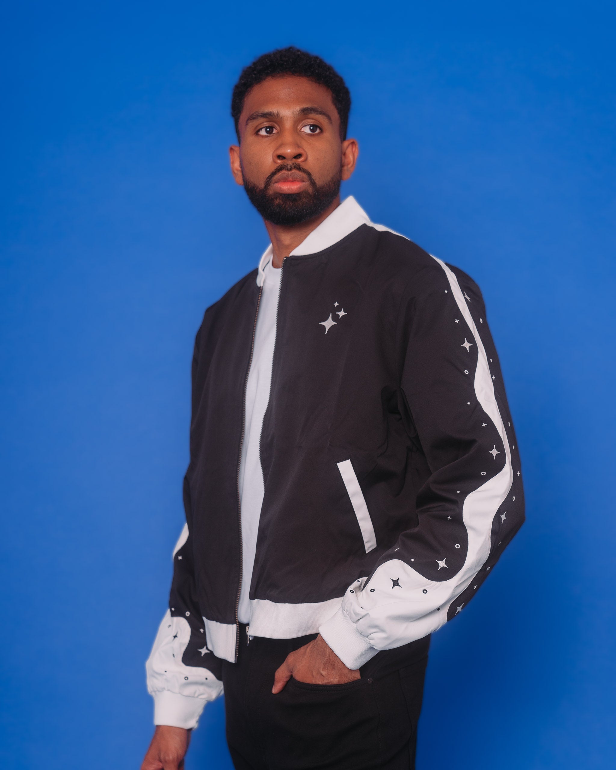 Man wearing deep space bomber jacket in size extra large in front of blue background.