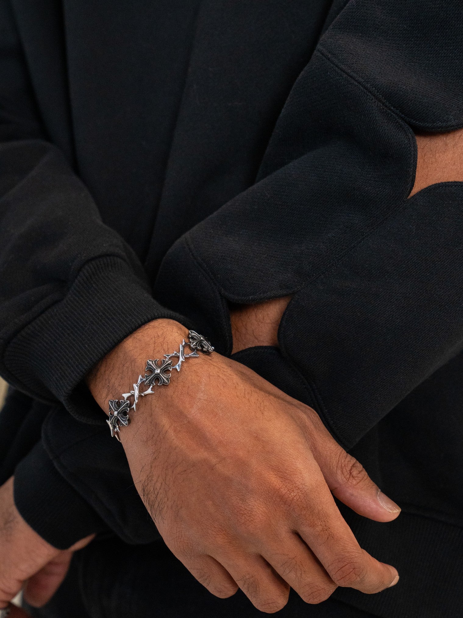 Close up of black deep space hoodie cuff and sleeve sparkle cutouts.