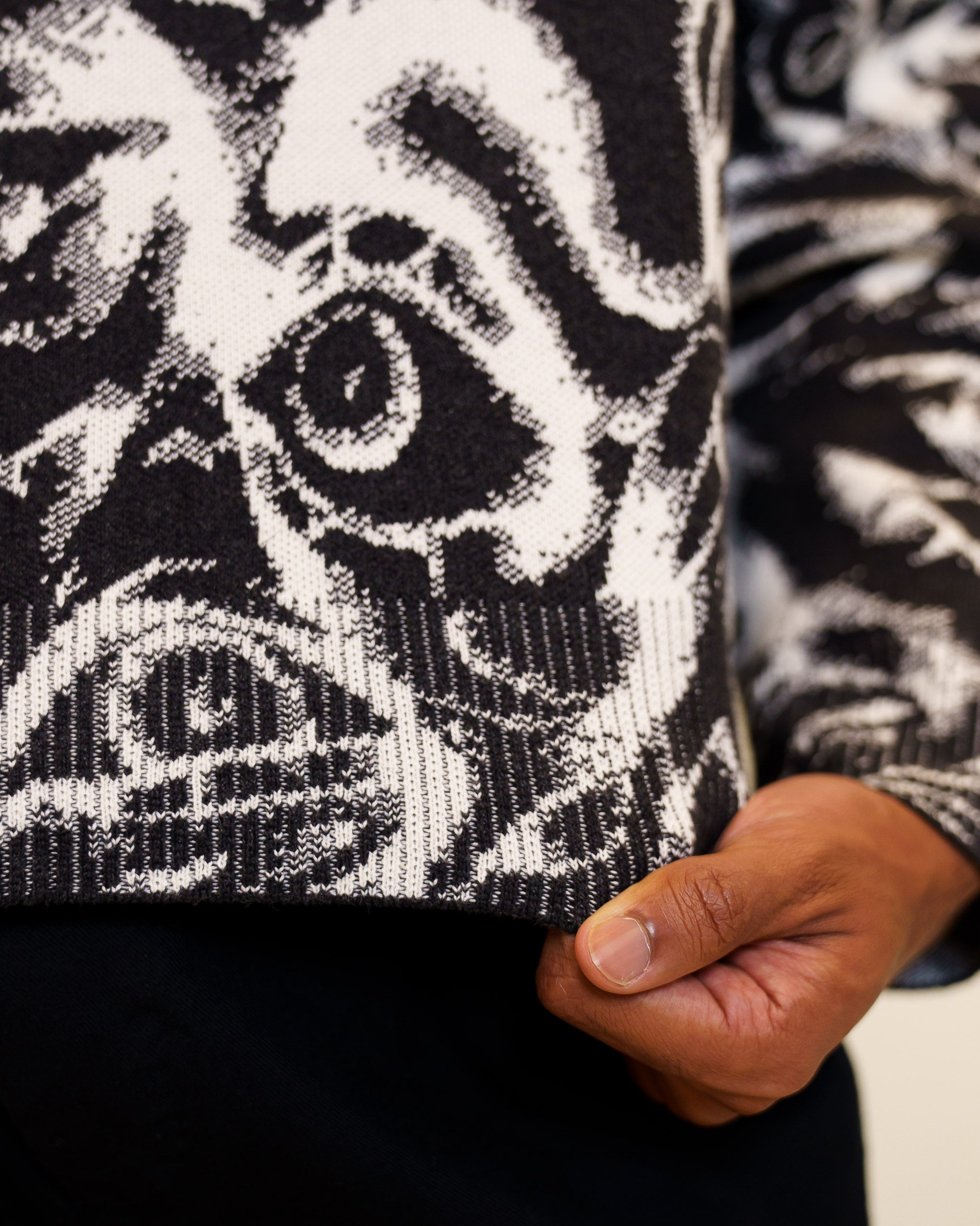 Close up of eyes on you knit sweater ribbed waistband. 