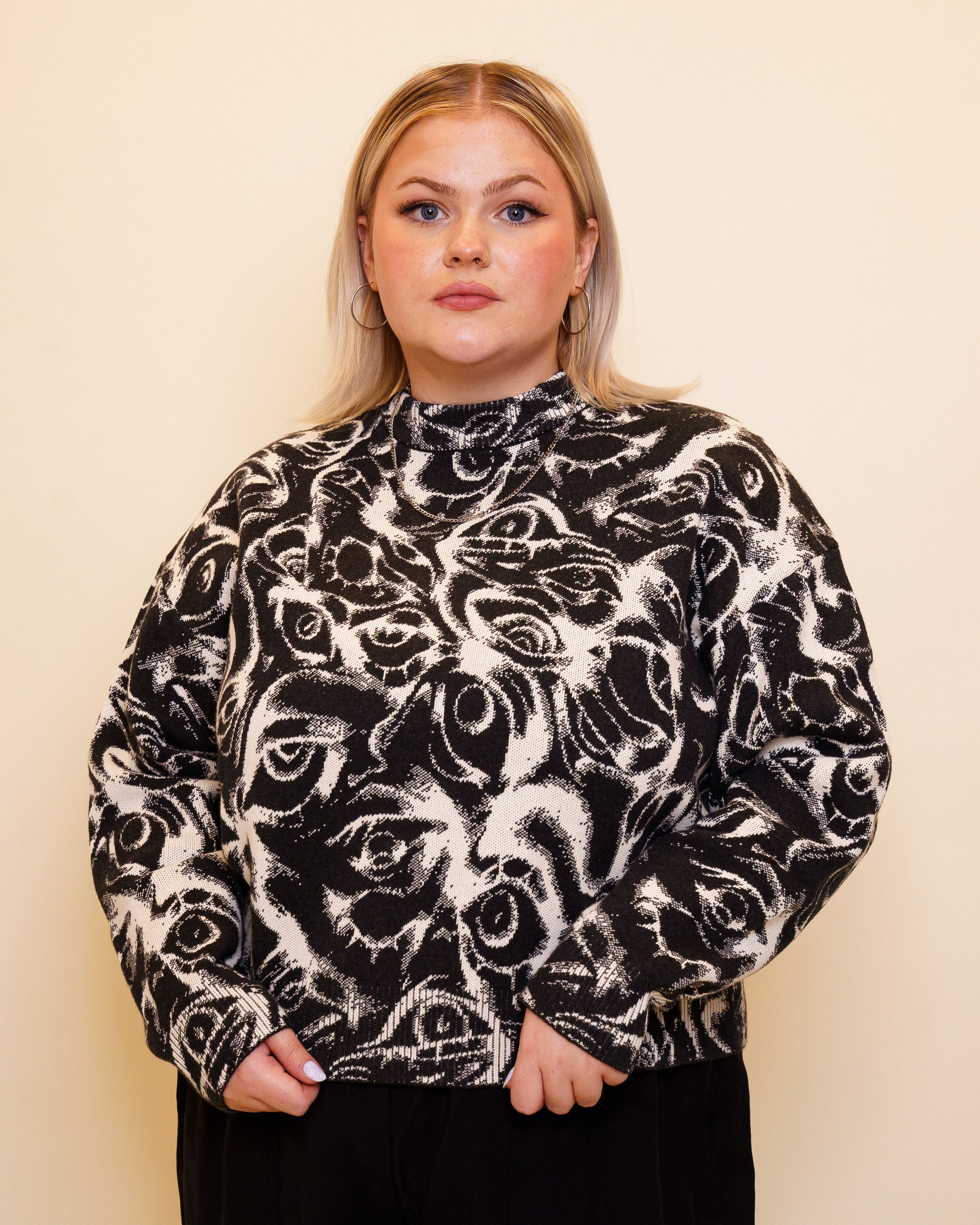 Woman wearing eyes on you cropped knit sweater in size large.