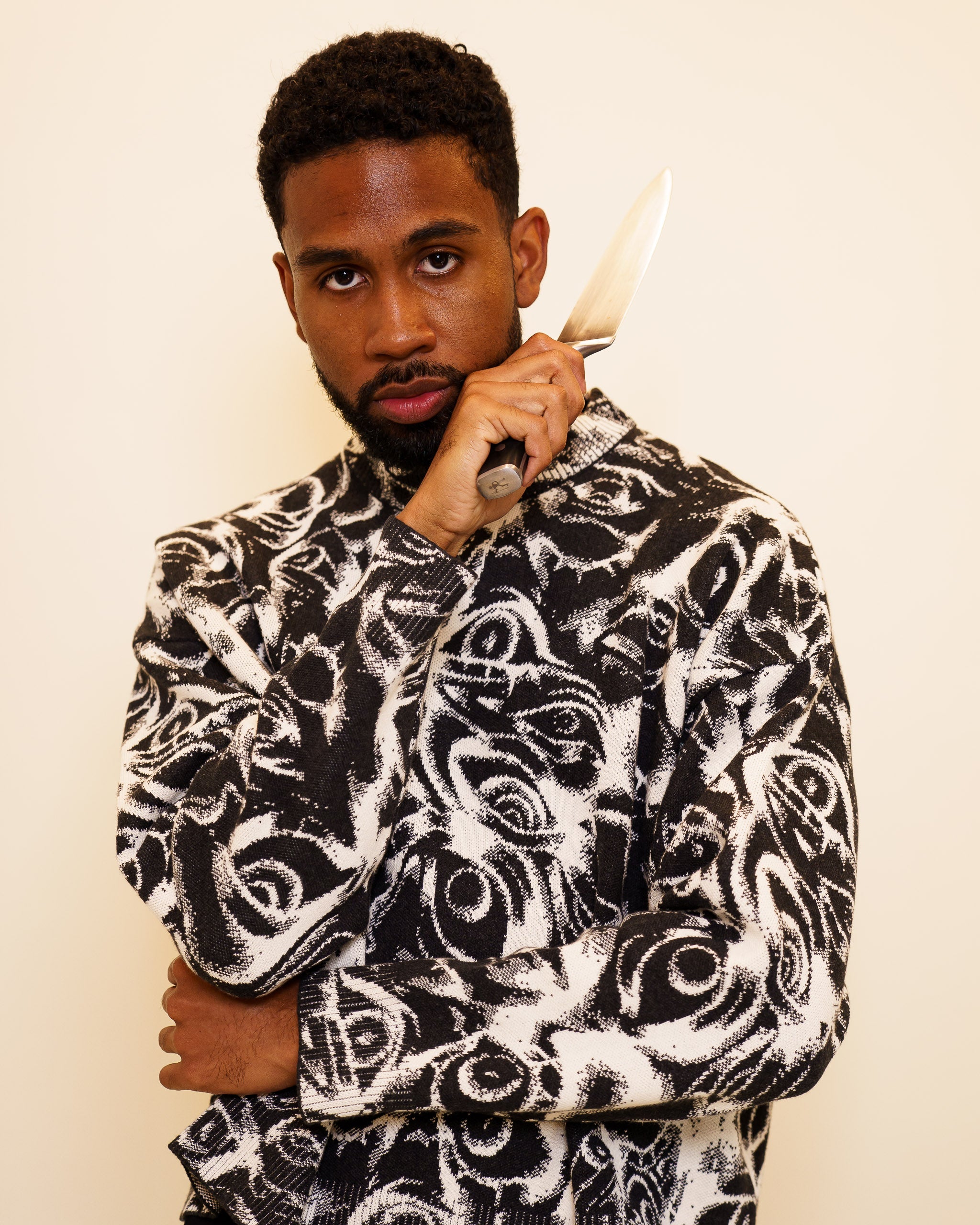 Man wearing eyes on you cropped knit sweater in size large.