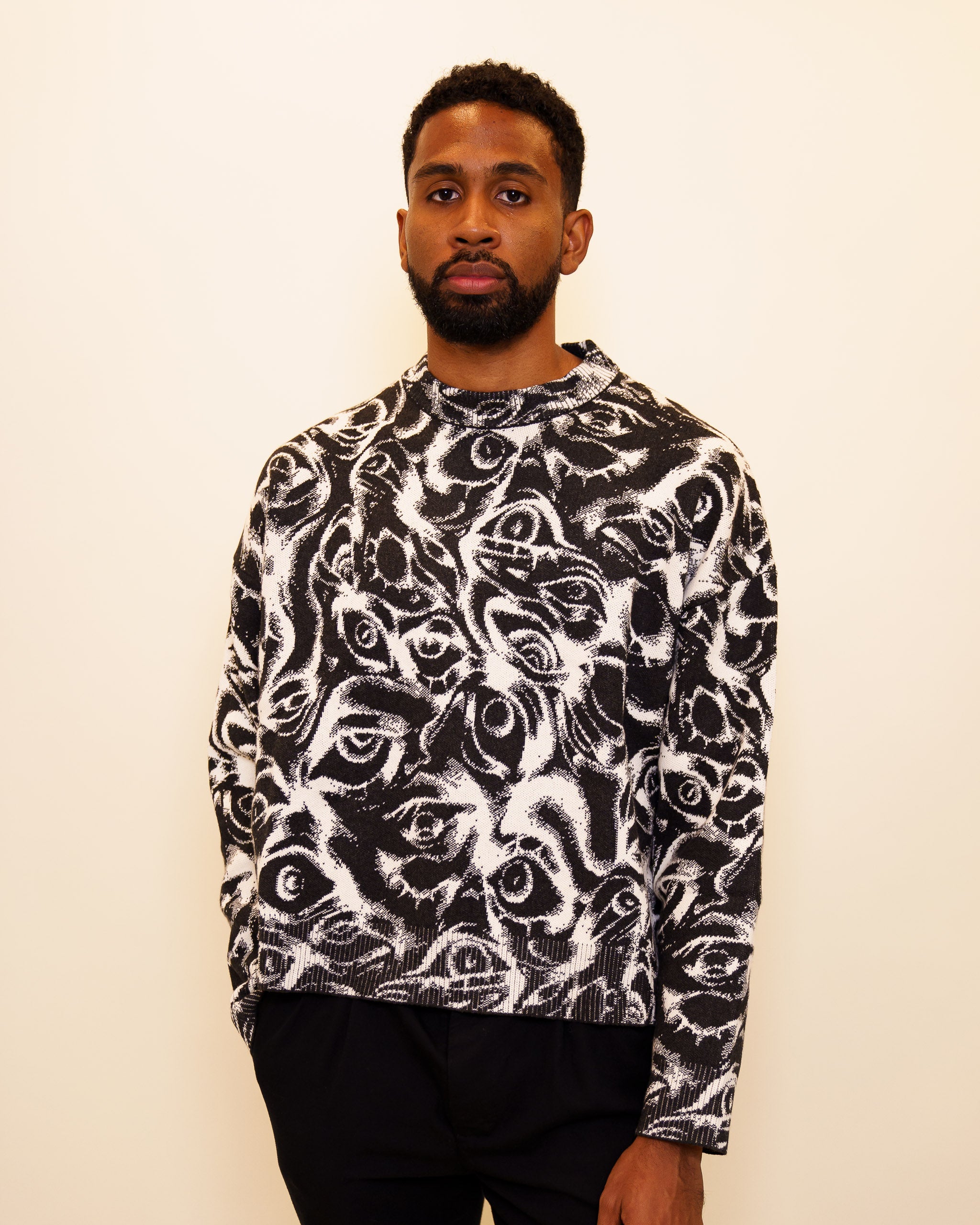 Man wearing eyes on you cropped knit sweater in size large.