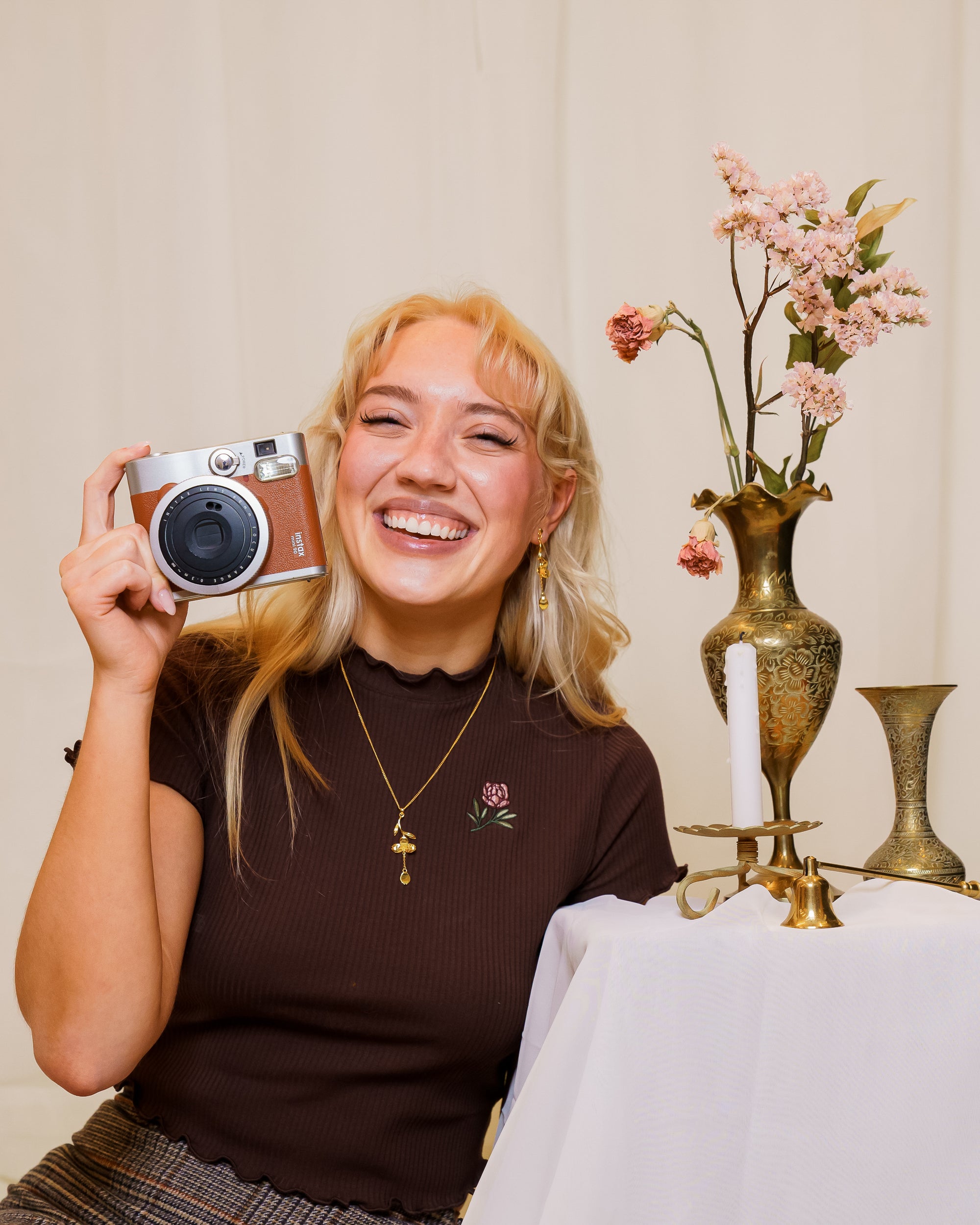 Woman wearing freshly picked brown mini tee sitting.