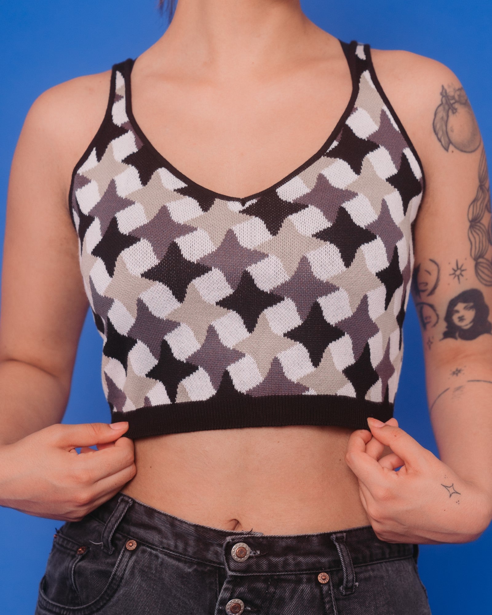 Woman wearing gunmetal knit tank in size medium. 