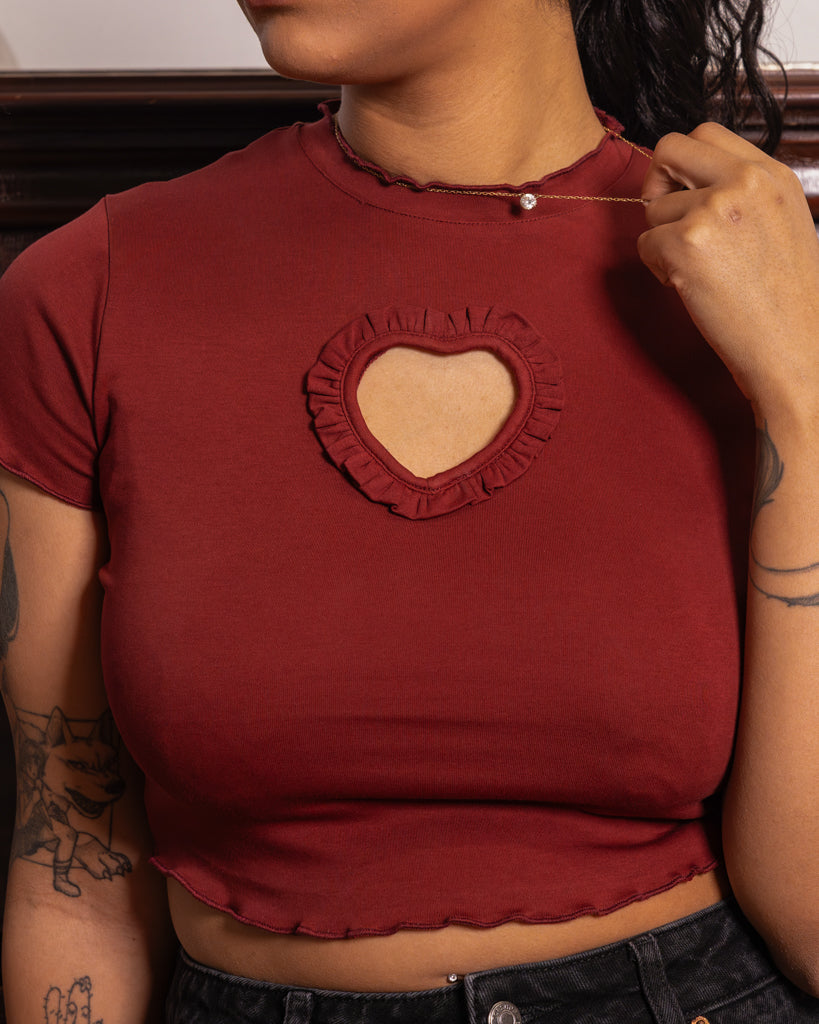 Close up of woman wearing red heart throb mini tee.