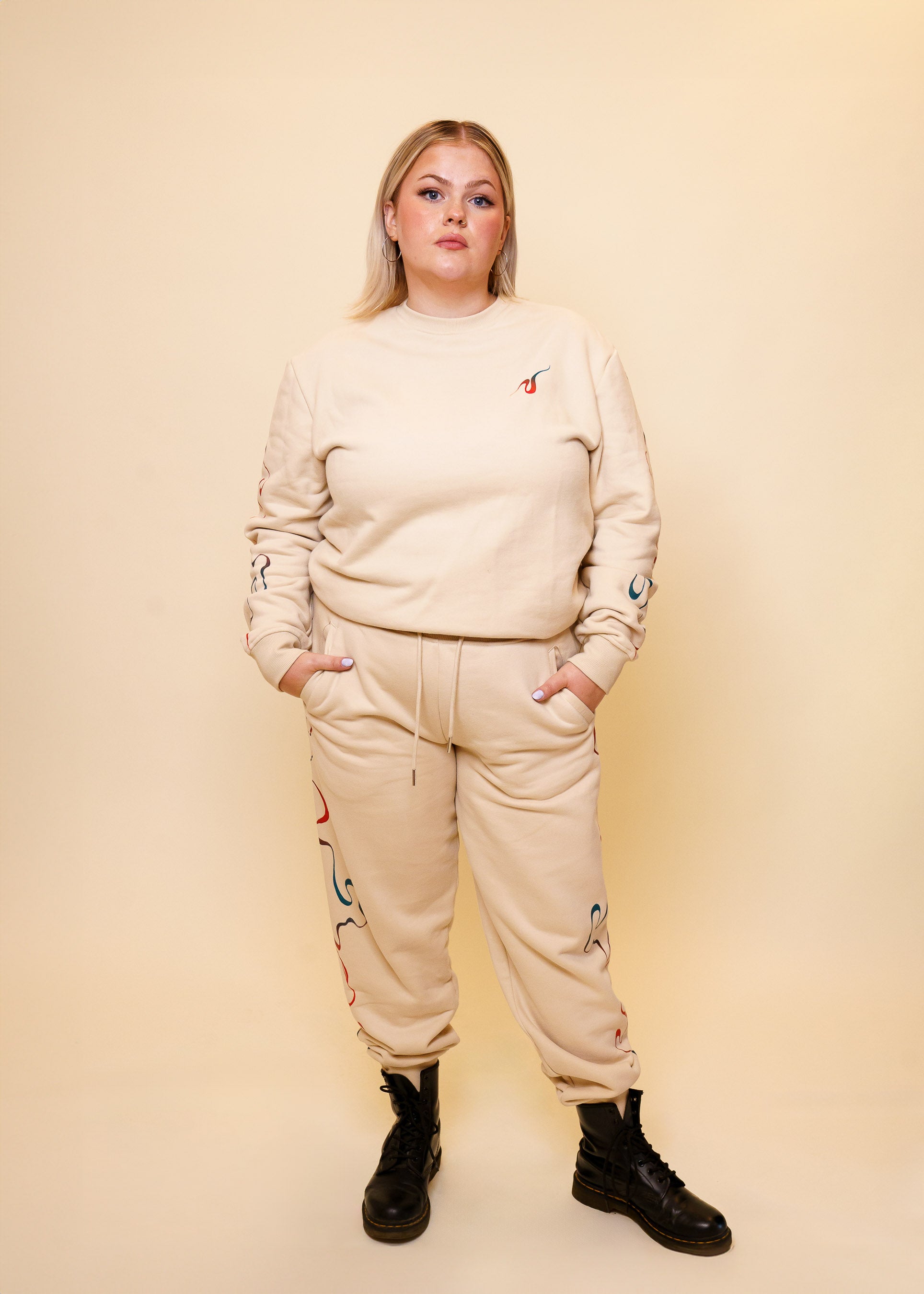 Woman wearing intuition joggers in size extra large with intuition crewneck.