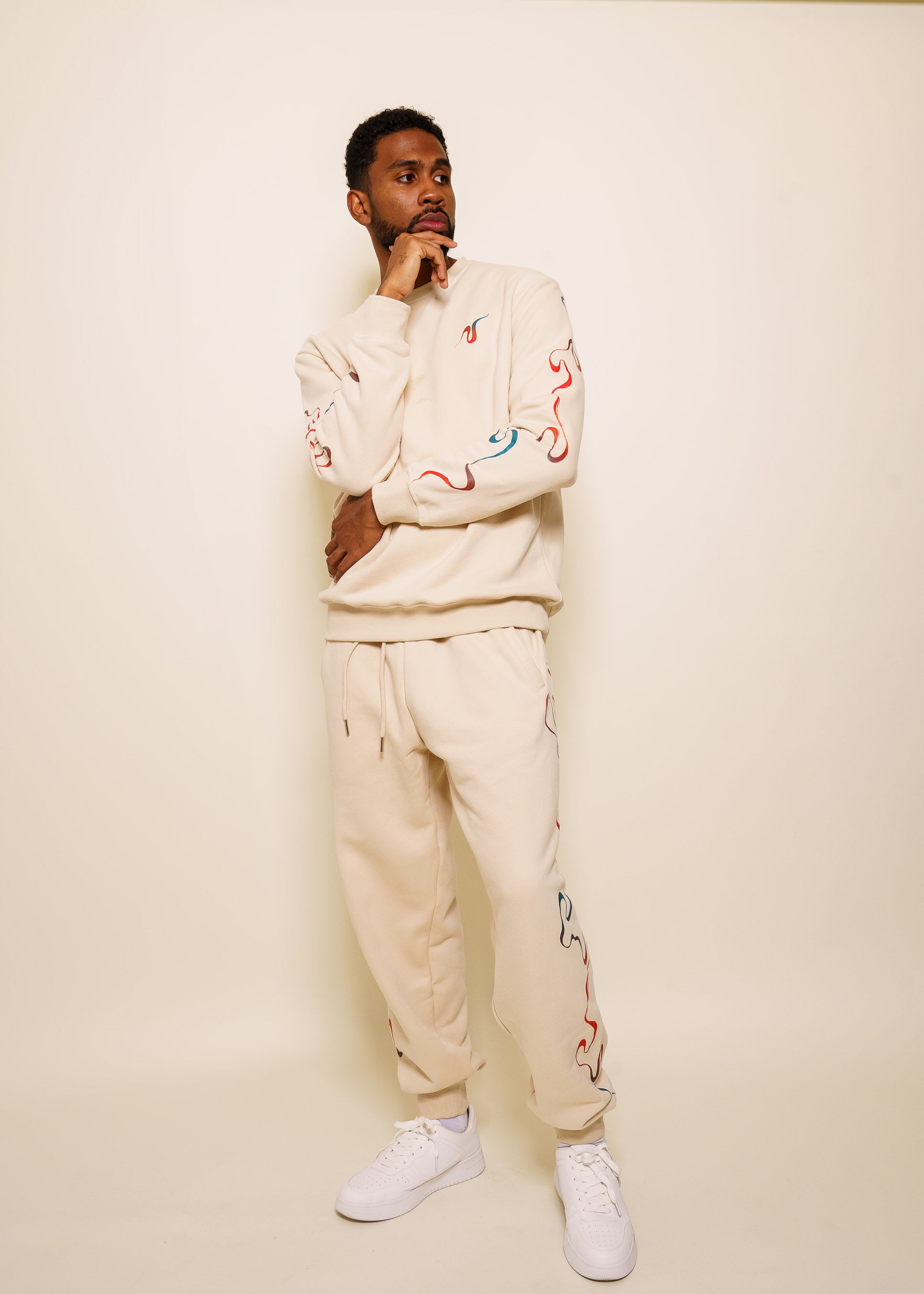 Man wearing intuition joggers in size extra large with intuition crewneck.