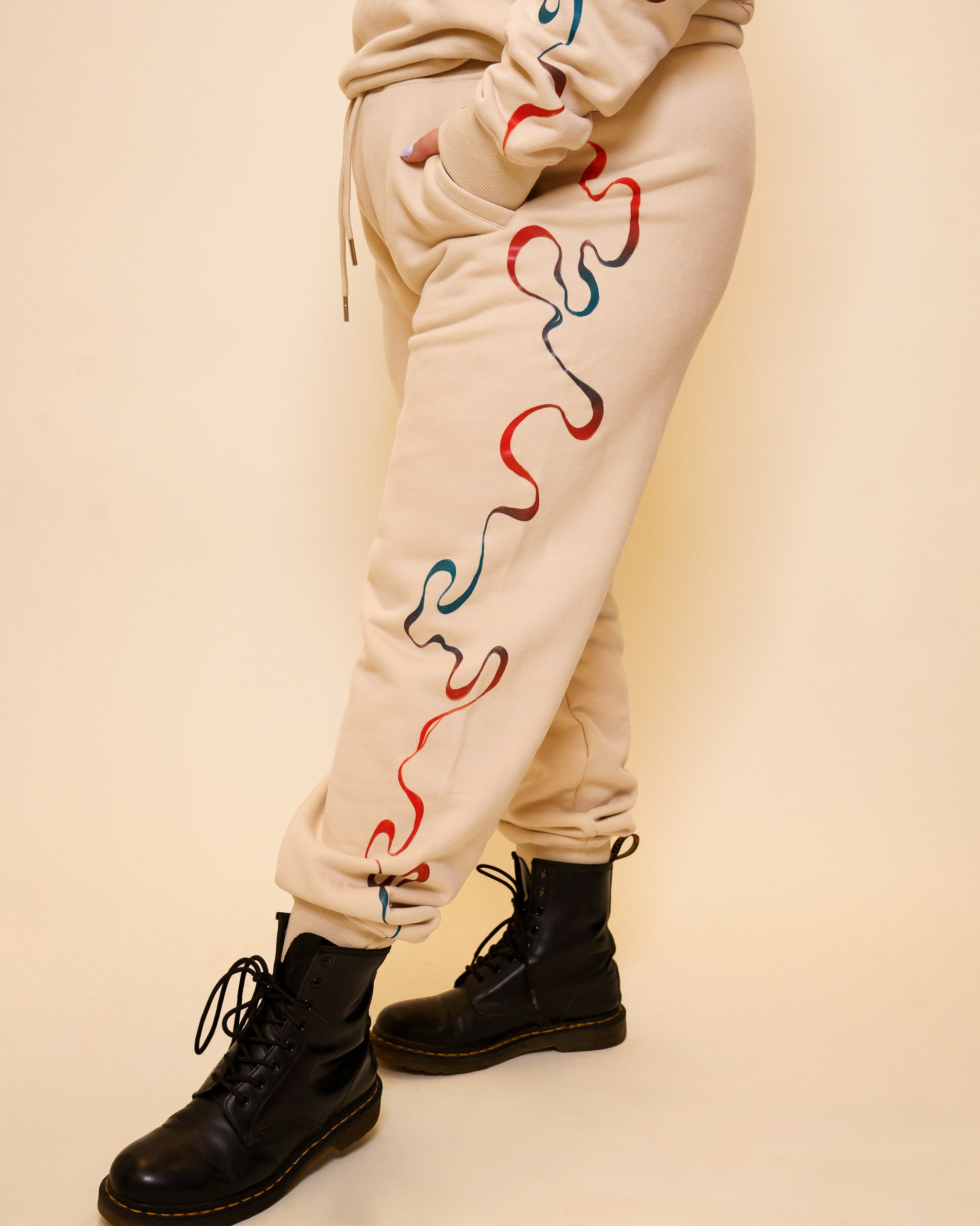 Intuition joggers side detail of wavy blue and red gradient line flowing down sides.