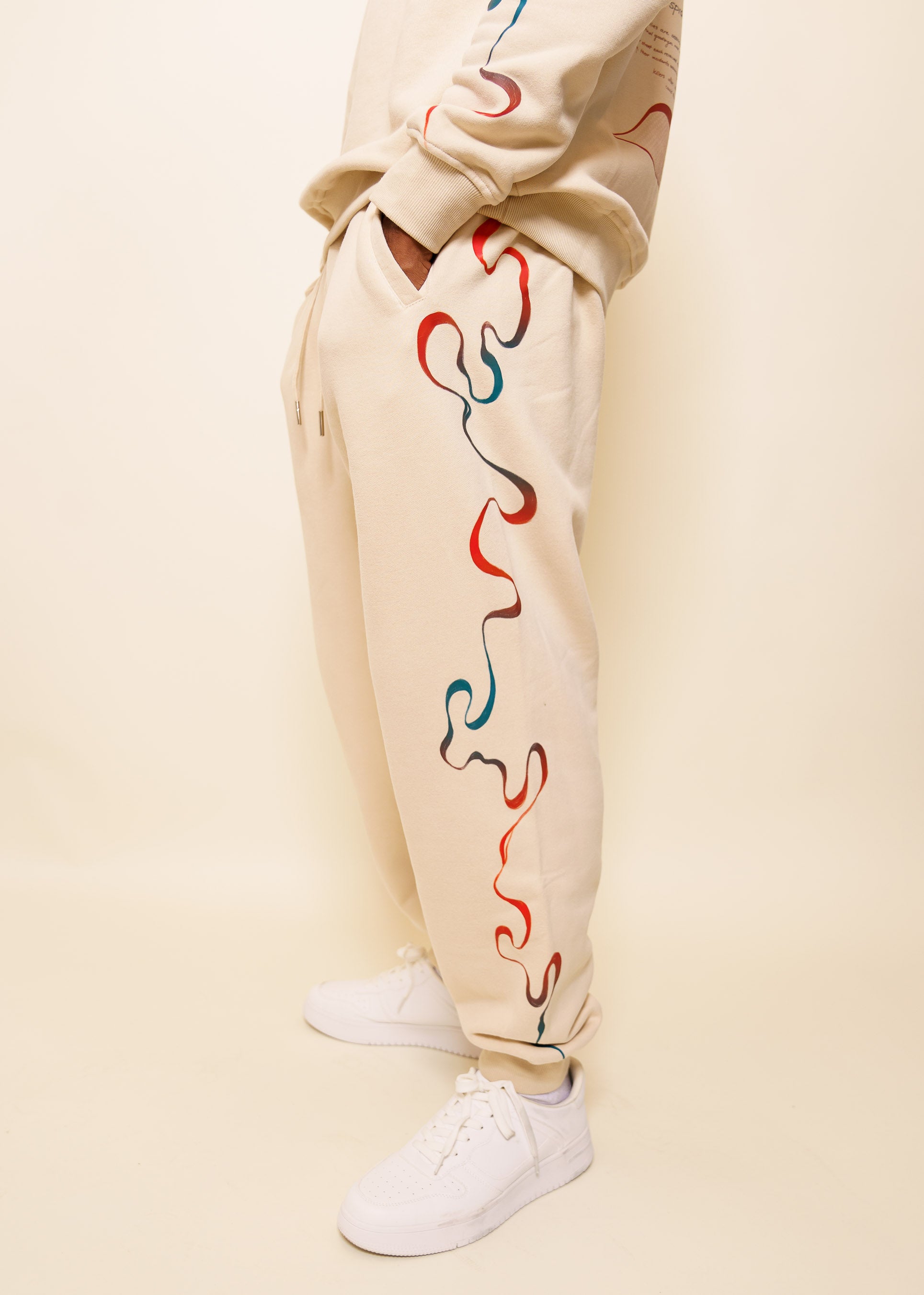 Side view of intuition joggers showing wavy red and blue gradient line flowing downwards.