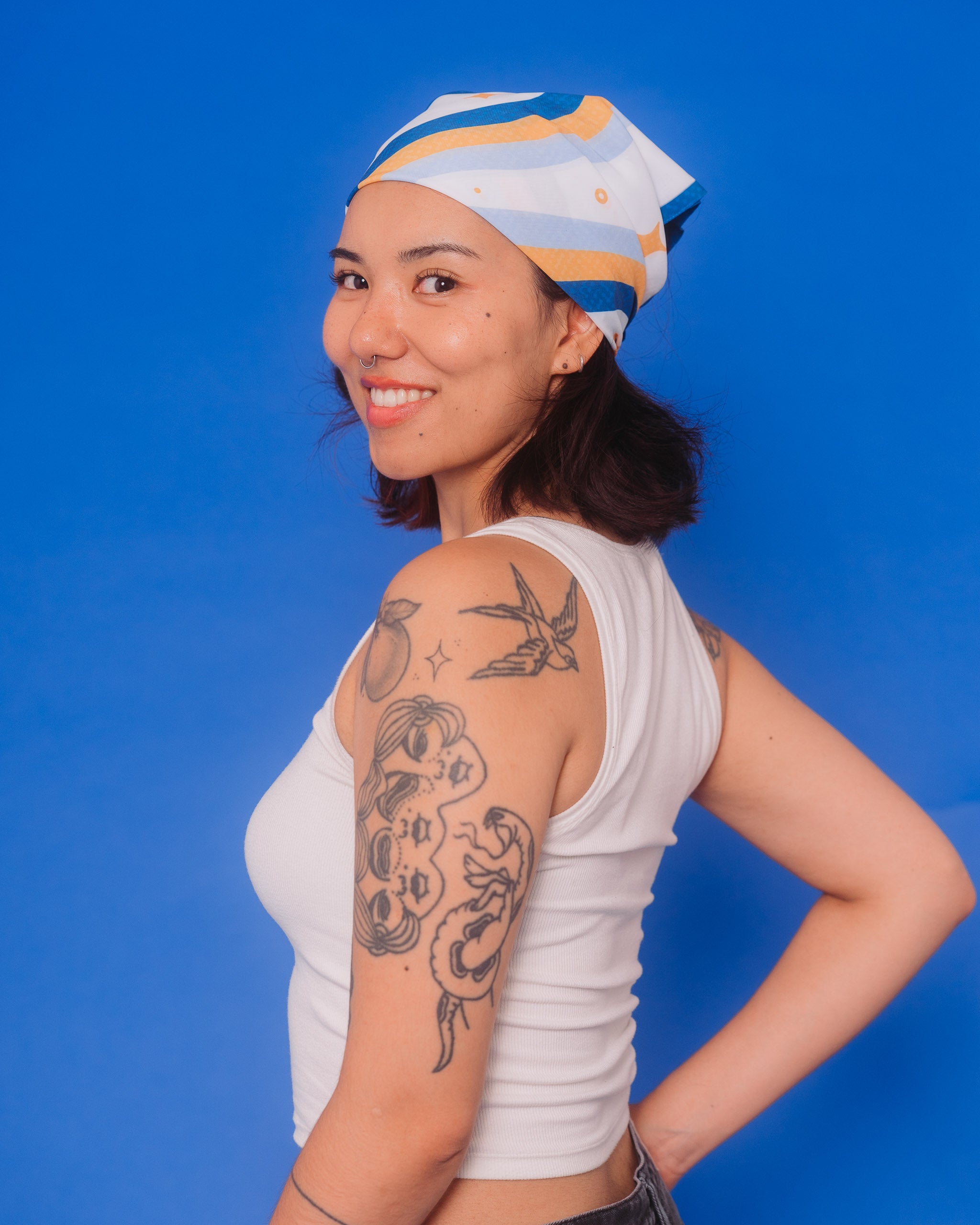 Woman wearing milky way bandanna on head.