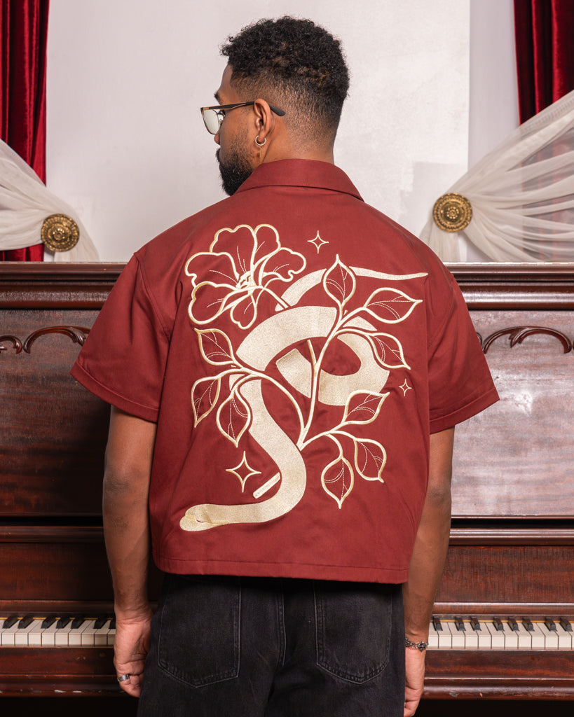 Back view of passionate boxy over-shirt in size extra large showcasing floral snake design embroidered in gold thread.