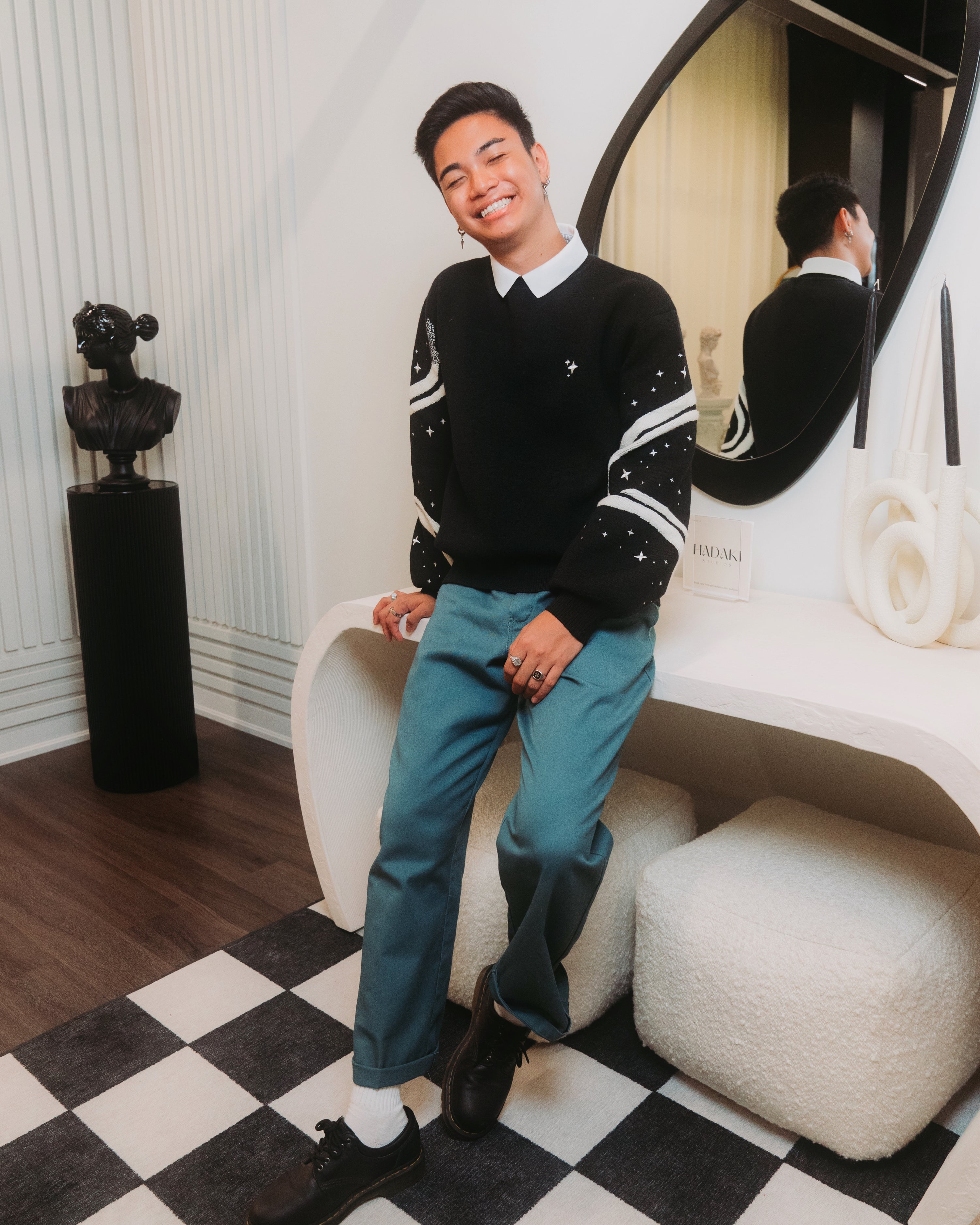 Man wearing black stargazer sweater.