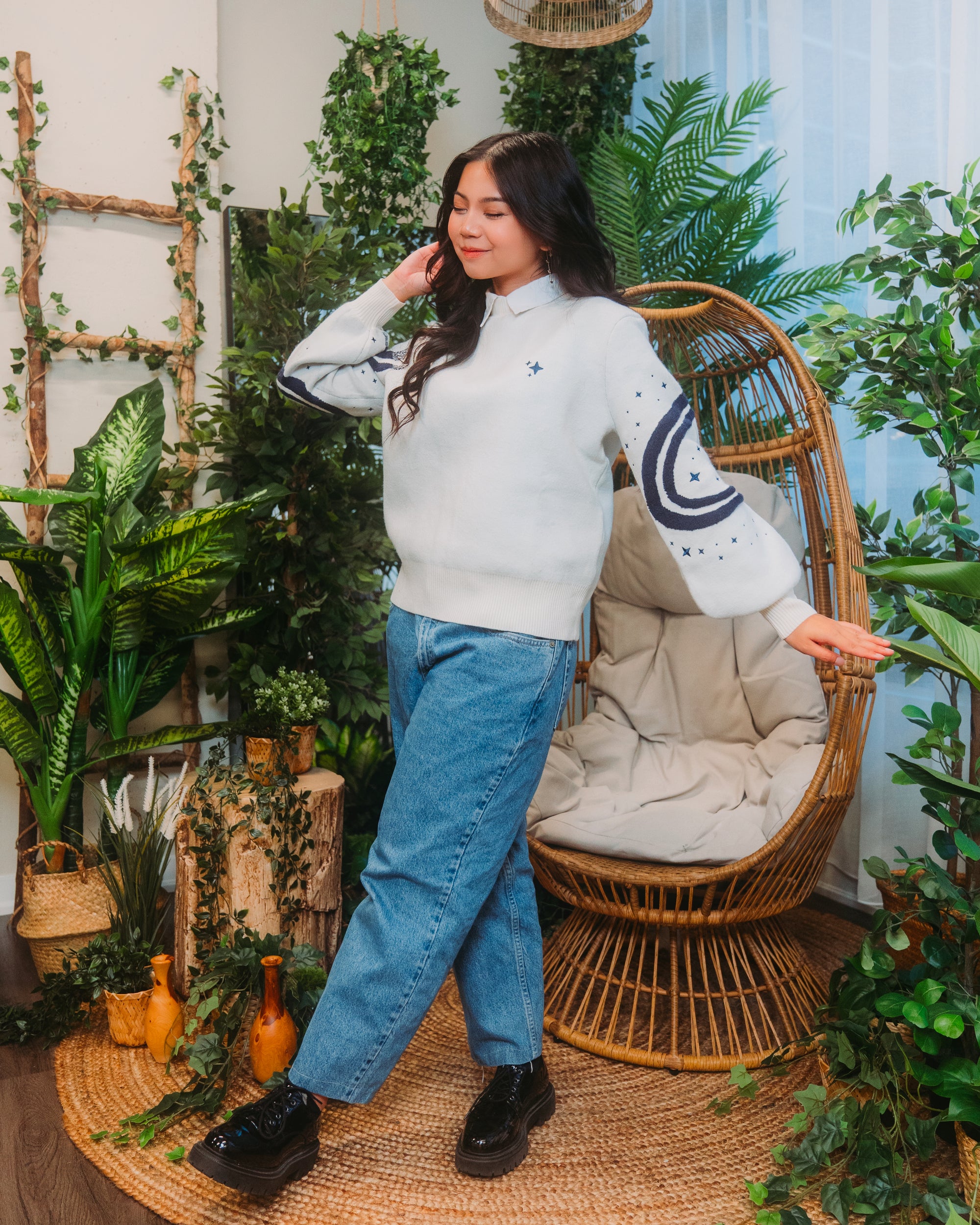 Woman wearing stargazer sweater in white.