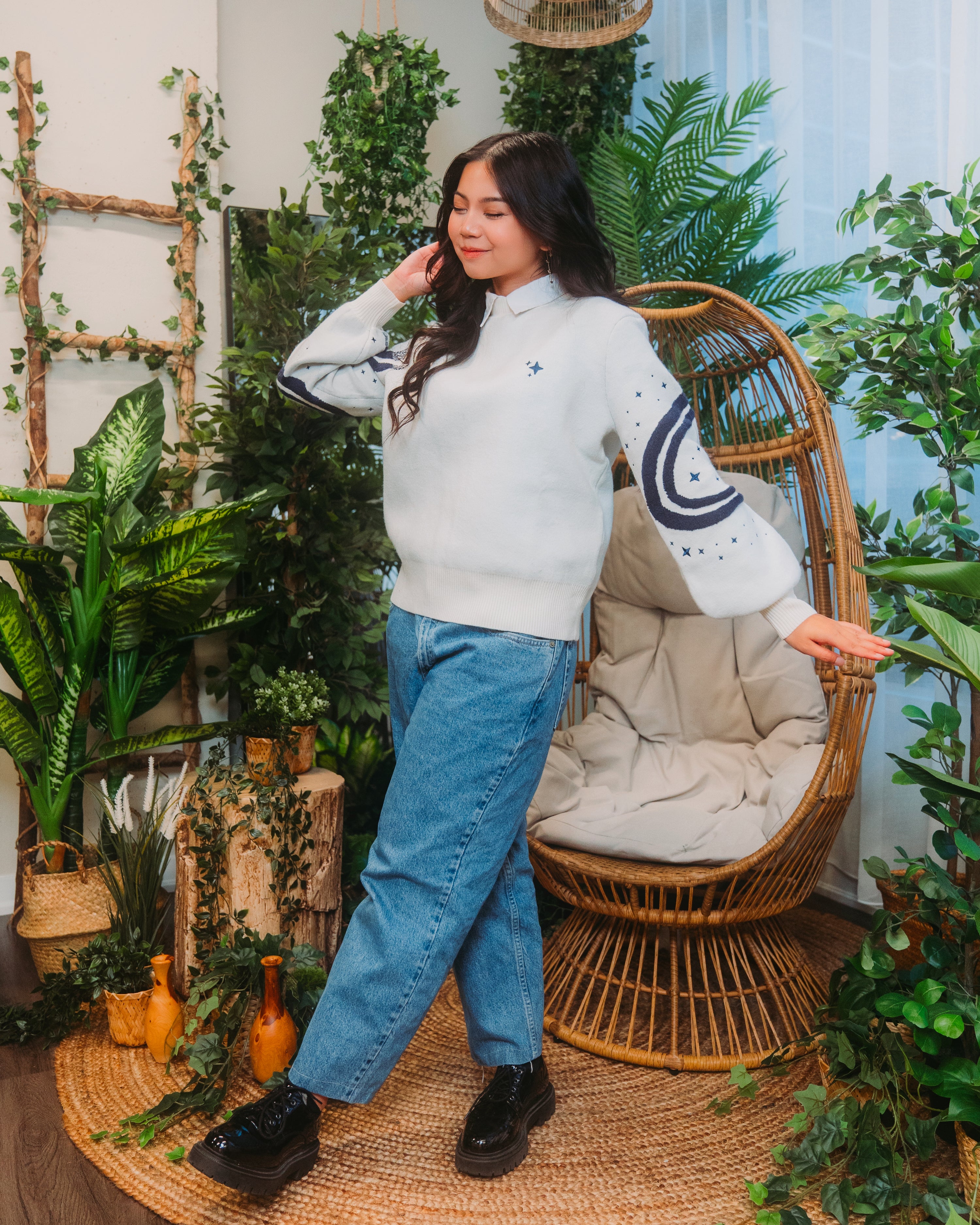 Woman wearing stargazer sweater in white.