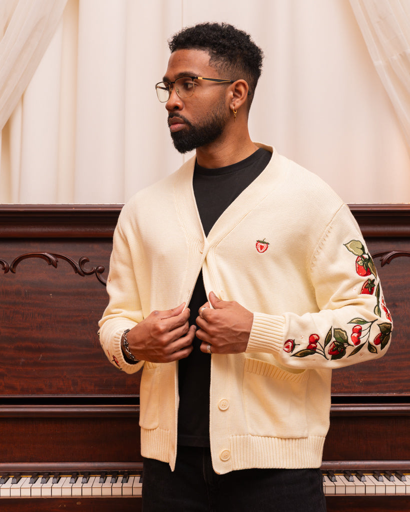 Man wearing strawberry cream cardigan in size large.
