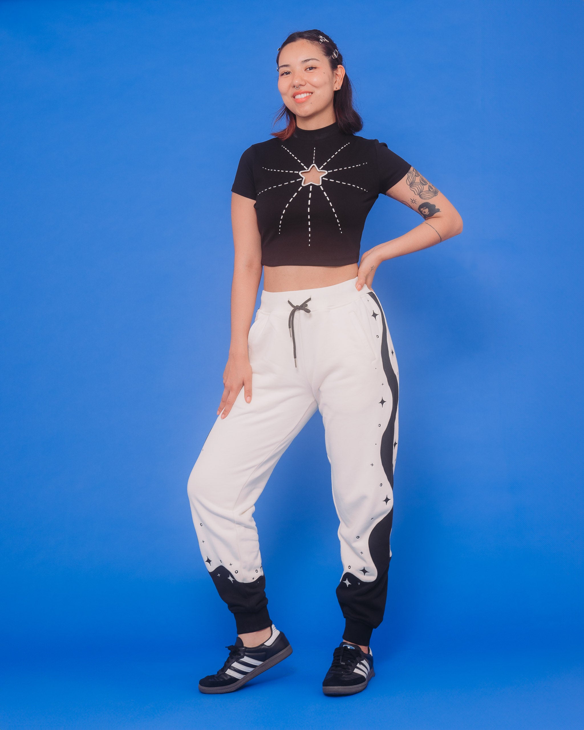 Woman wearing supernova joggers in size medium in front of blue background.