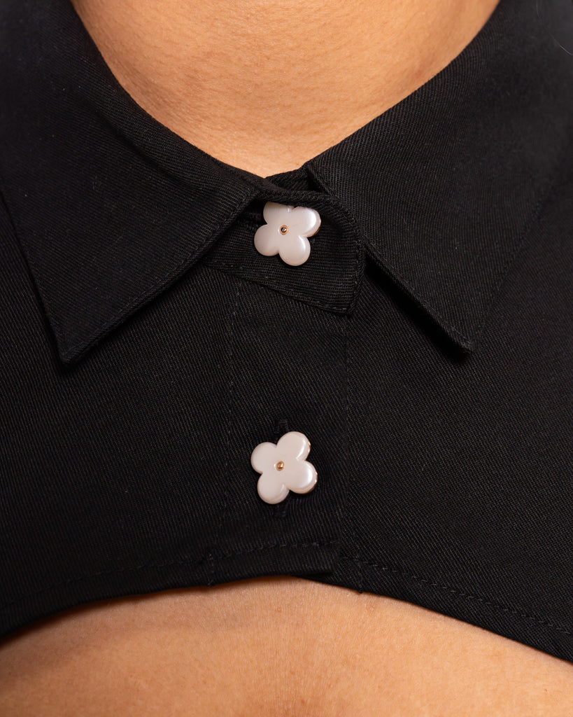 Close up of sweetheart black bolero shirt centre flower buttons.
