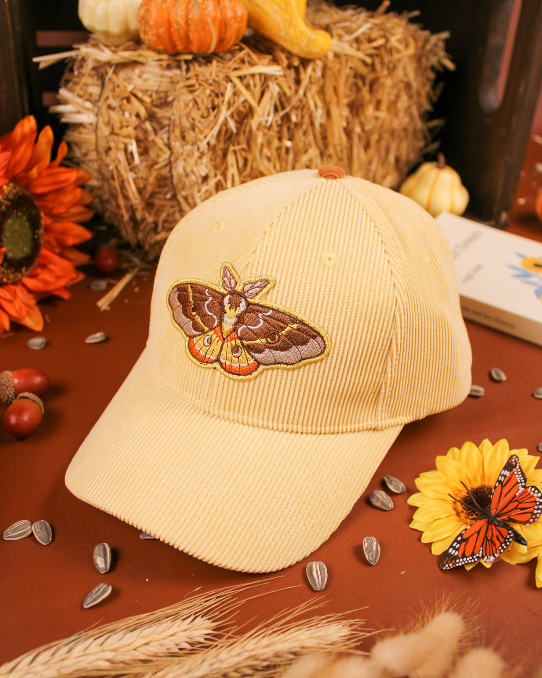 Emperor moth cap in cream.